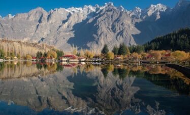 Beautiful reflection of mountains and autumn foliage at Shangrila Lake, Skardu, Pakistan.