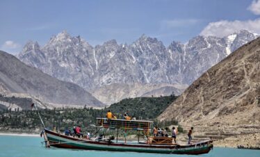 Experience the breathtaking landscapes of Hunza Nagar with a scenic boat ride under majestic mountain peaks. 5 Days Hunza Couple Trip