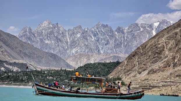 Experience the breathtaking landscapes of Hunza Nagar with a scenic boat ride under majestic mountain peaks. 5 Days Hunza Couple Trip