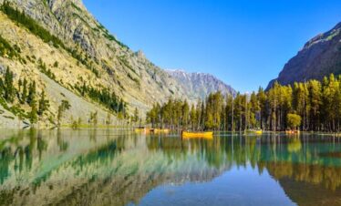Stunning view of Mahodand Lake in Kalam, surrounded by mountains and vibrant forests.