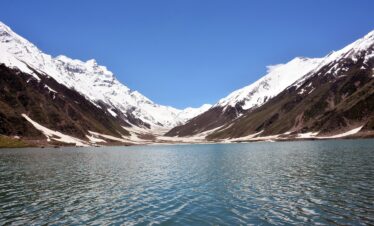 Naran Kaghan tour — Lake Saiful Muluk with snow-capped peaks reflected in glacial water, Kaghan Valley