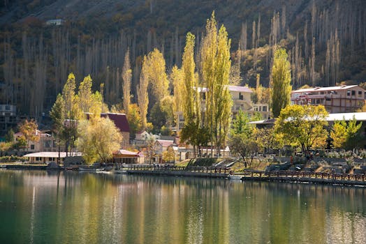 Beautiful autumn scene of Skardu with colorful trees, tranquil lake, and reflections.