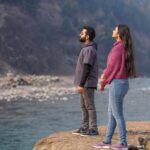 Couple on Naran honeymoon tour package walking through Shogran Siri Paye alpine meadows in summer