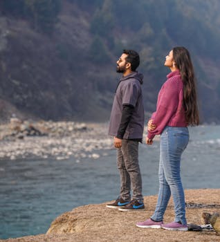 Couple on Naran honeymoon tour package walking through Shogran Siri Paye alpine meadows in summer