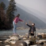 Neelum valley couple trip with turquoise river and mountain backdrop 2026