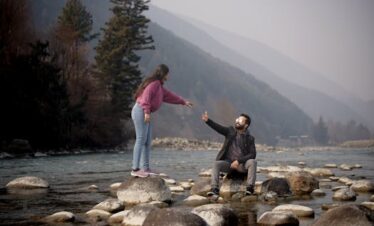 Neelum valley couple trip with turquoise river and mountain backdrop 2026