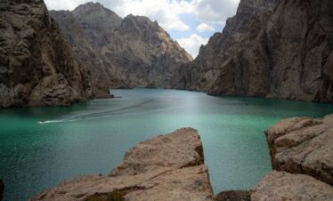 • 4 days hunza valley tour package showing attabad lake turquoise waters aerial view