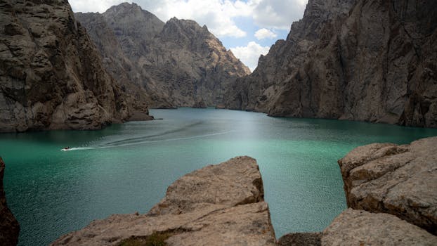 • 4 days hunza valley tour package showing attabad lake turquoise waters aerial view